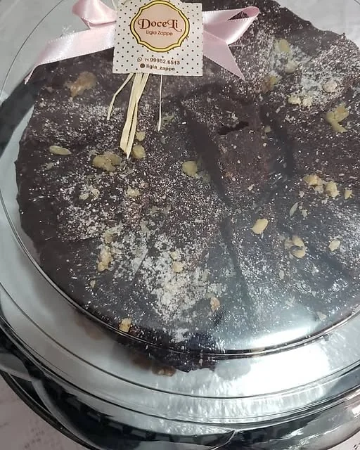 Torta de chocolate embalada com a etiqueta da DoceLi e laço rosa